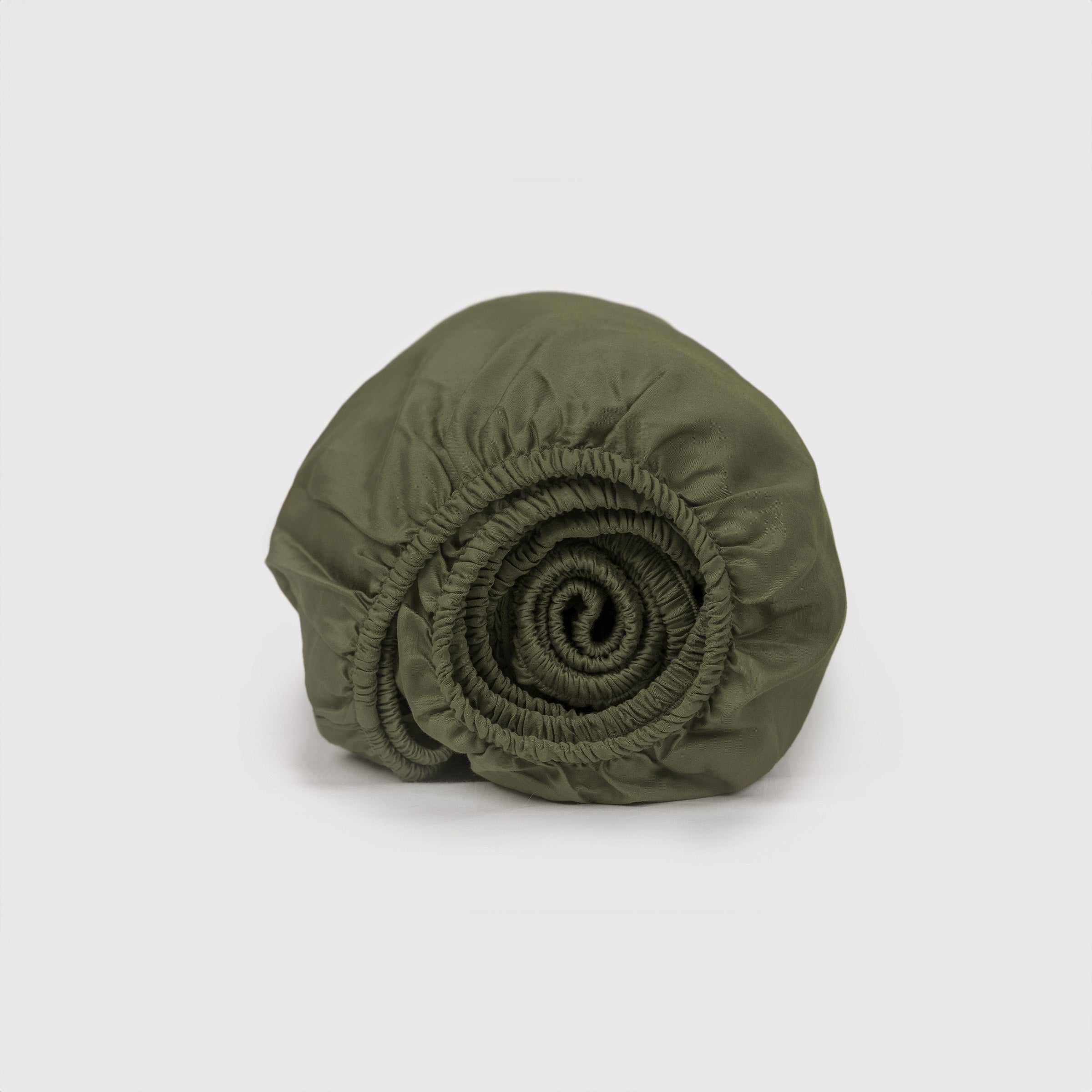 organic-crisp-baby-cot-fitted-sheet-in-olive-colour-inside-a-cot-by-sojao