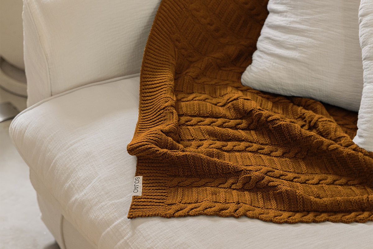 organic-cotton-cable-knit-throw-in-mustard-colour-on-the-sofa-by-sojao