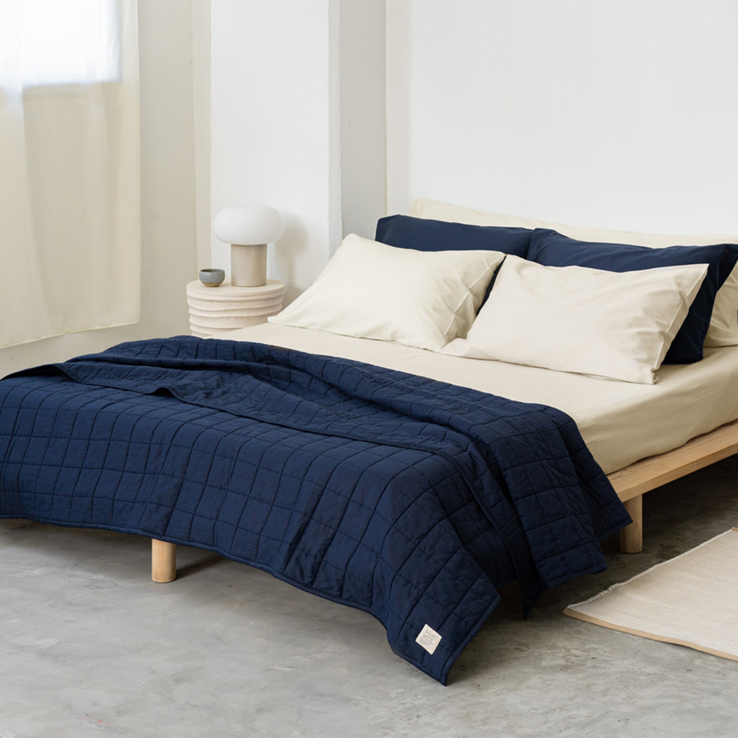 organic-cotton-quilt-in-navy-colour-inside-bedroom-by-sojao