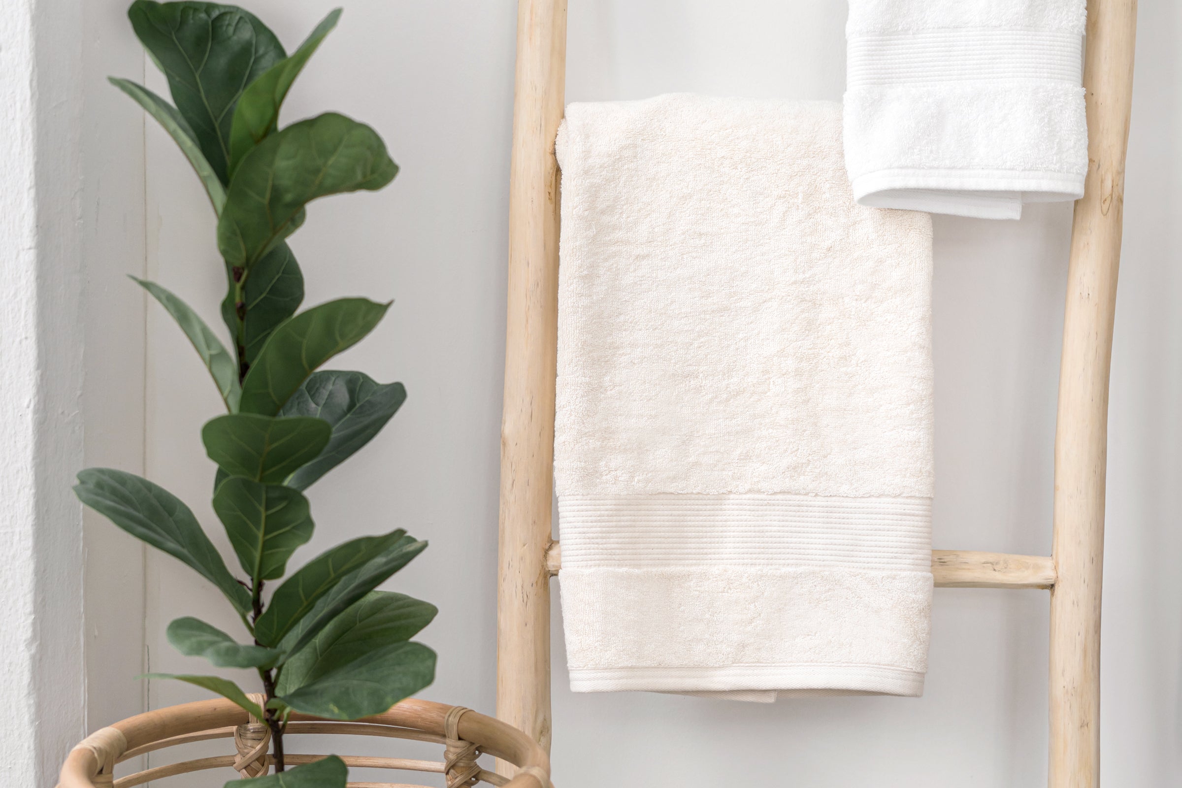 organic-cotton-hand-towel-in-natural-colour-hanging-over-a-wooden-ladder-by-sojao